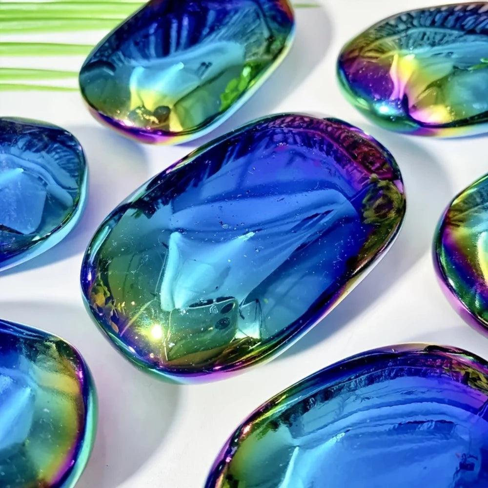 Polished Aura Obsidian palm stones with iridescent blue and violet shimmers for grounding and spiritual protection.