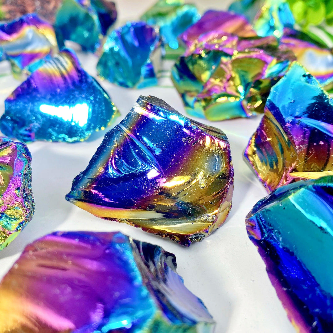 Raw Aura Obsidian crystal stone with iridescent gold, violet, and teal flashes for grounding protection.