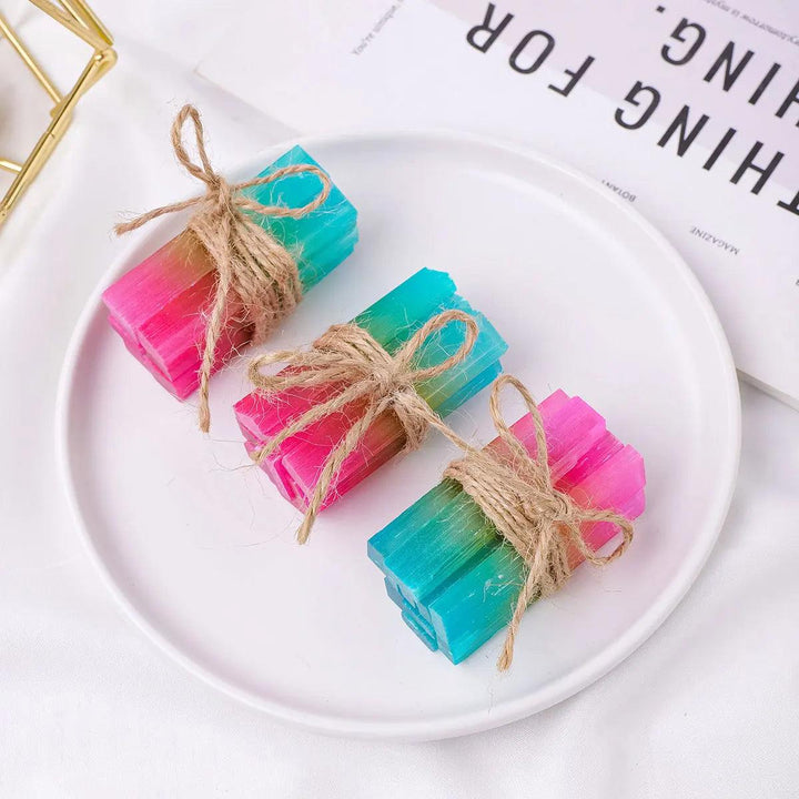 Three Aura Selenite crystal sticks with iridescent rainbow coatings, tied with twine for cleansing and healing rituals.
