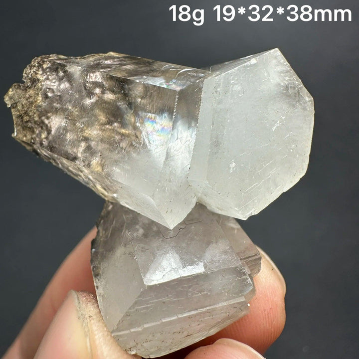 Natural clear aurora columnar calcite cluster crystal with rainbow inclusions for healing decor.