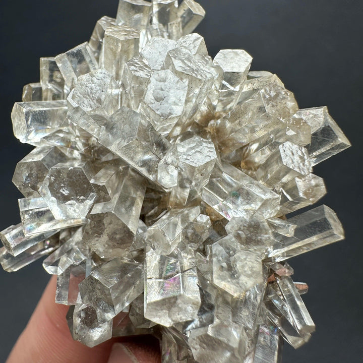 Natural clear aurora columnar calcite cluster flower healing stone with prismatic crystals.