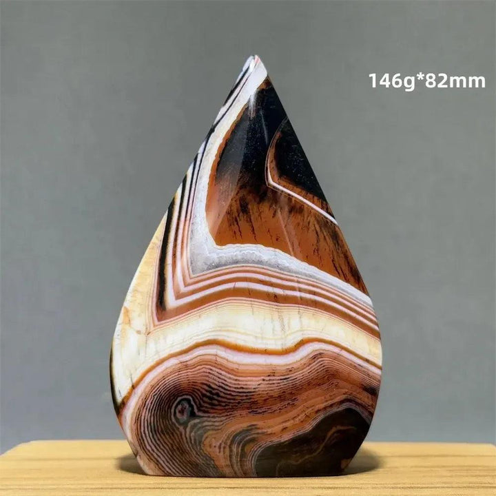 Banded Agate freeform torch from Crystal Destiny, featuring warm creams, browns, and white concentric stripes.