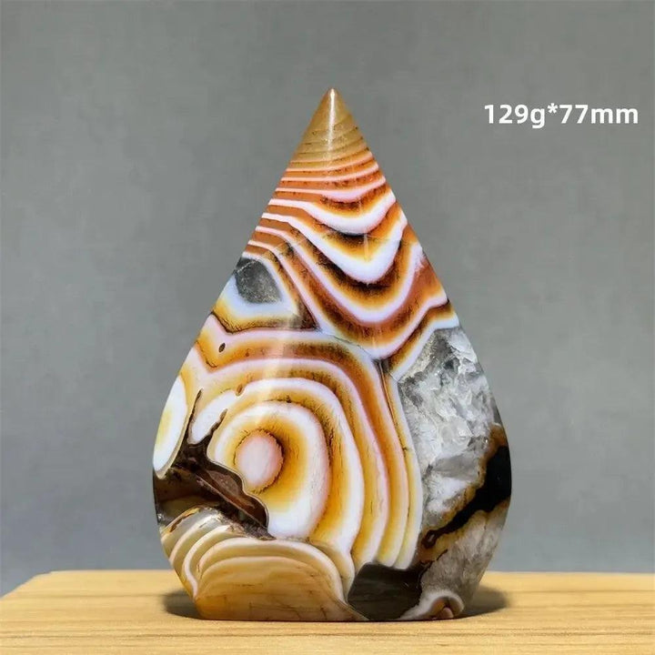 Crystal Destiny's banded agate freeform torch, 129g*77mm, with warm creams, tans, and white concentric stripes.