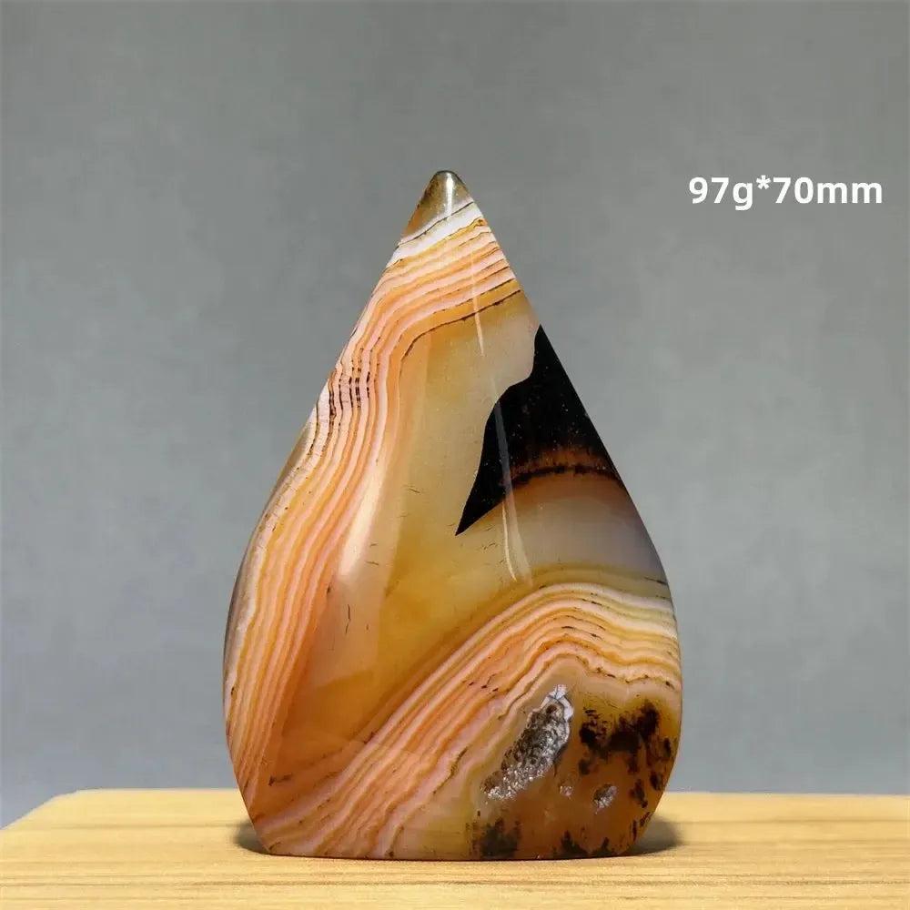 Banded Agate freeform torch from Crystal Destiny, 97g, 70mm, with warm orange, brown, and cream layers.