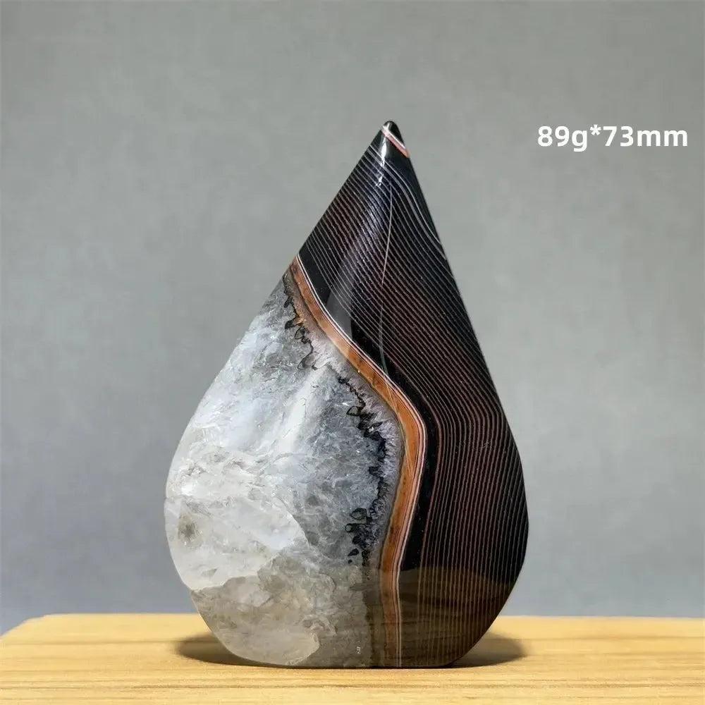Banded Agate freeform torch from Crystal Destiny, featuring black, white, and brown layers with a clear quartz base.