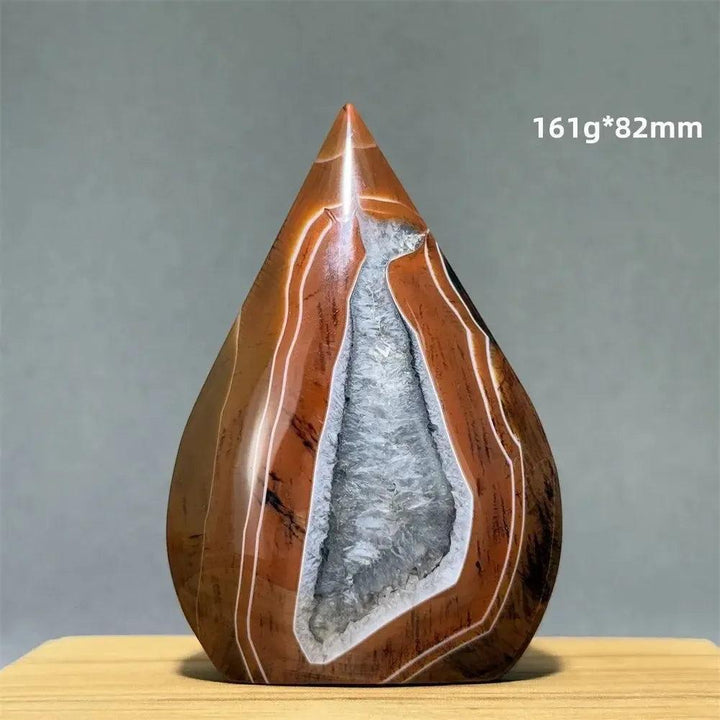 Crystal Destiny's banded agate freeform torch, a grounding brown and white mineral specimen with a geode center.