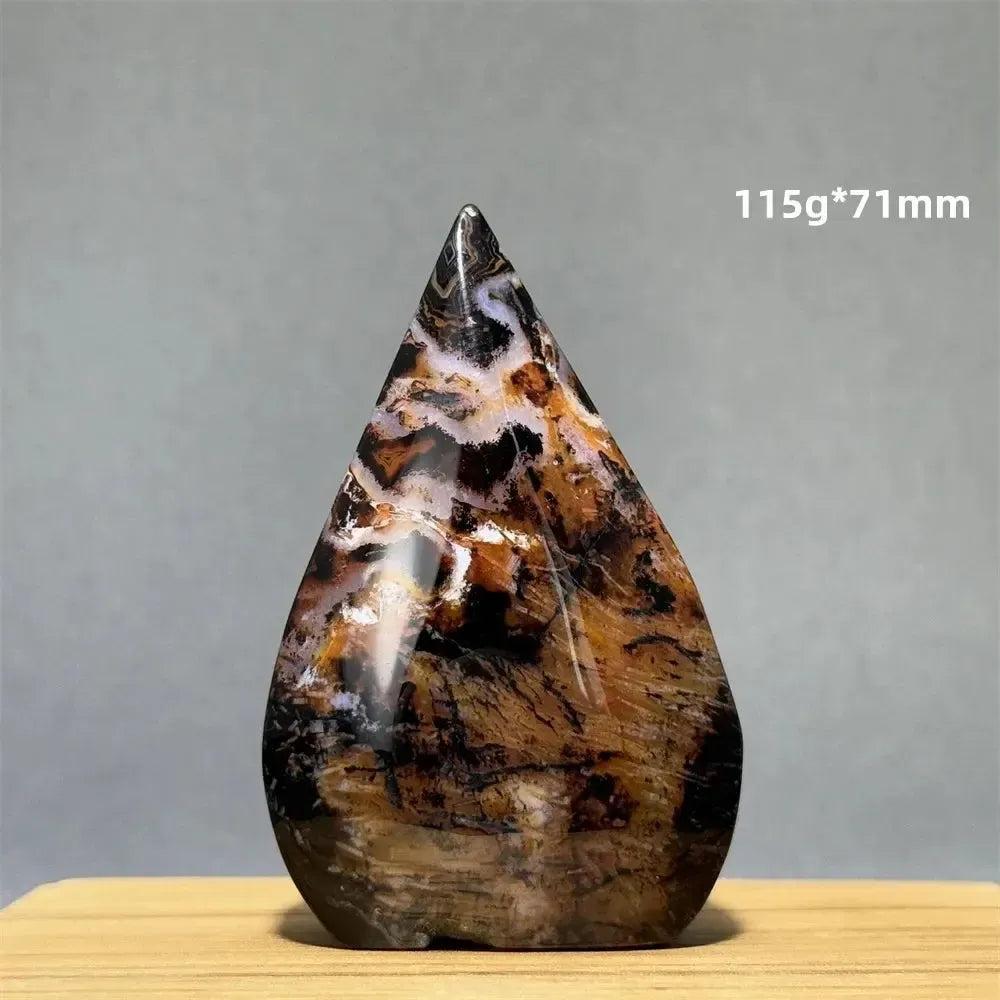 Banded Agate freeform torch from Crystal Destiny, with warm creams, browns, and black patterns, for grounding.