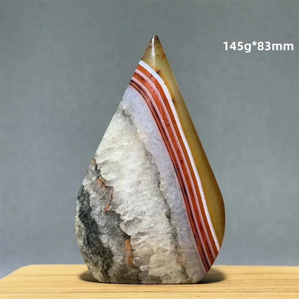 Crystal Destiny's banded agate freeform torch, with warm creams, tans, and rust stripes, and a raw druzy base.