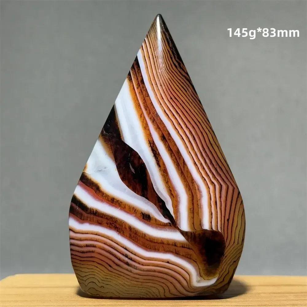Banded Agate freeform torch from Crystal Destiny, featuring warm brown, white, and black concentric layers.