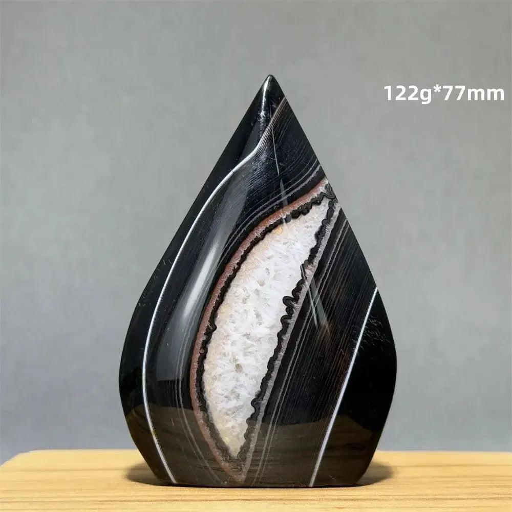 Banded Agate freeform torch from Crystal Destiny, featuring black, white, and brown concentric stripes.