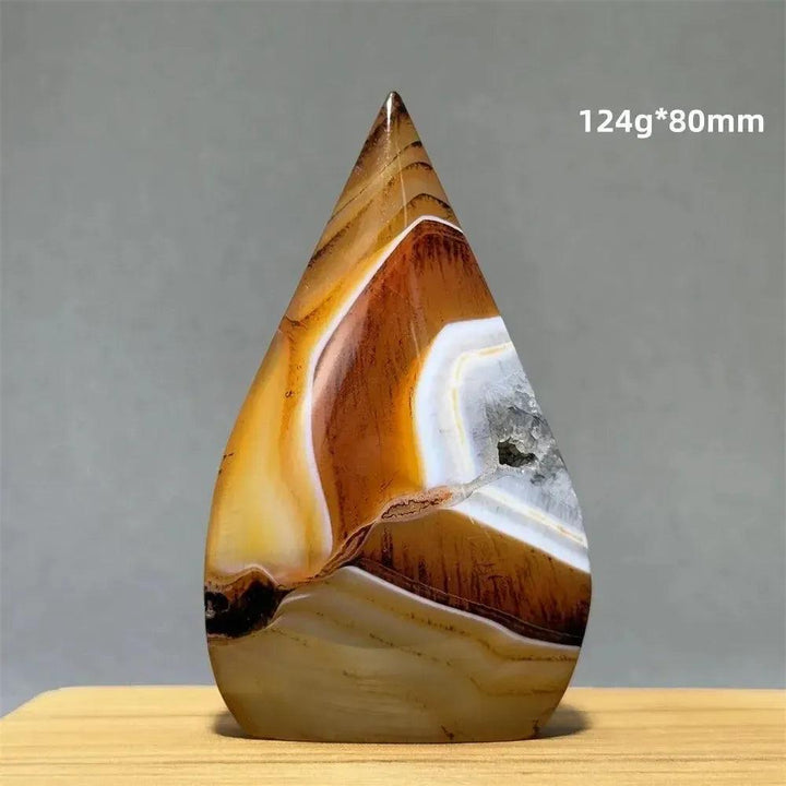Banded Agate freeform torch from Crystal Destiny, featuring warm browns, creams, and white bands with a geode cavity.