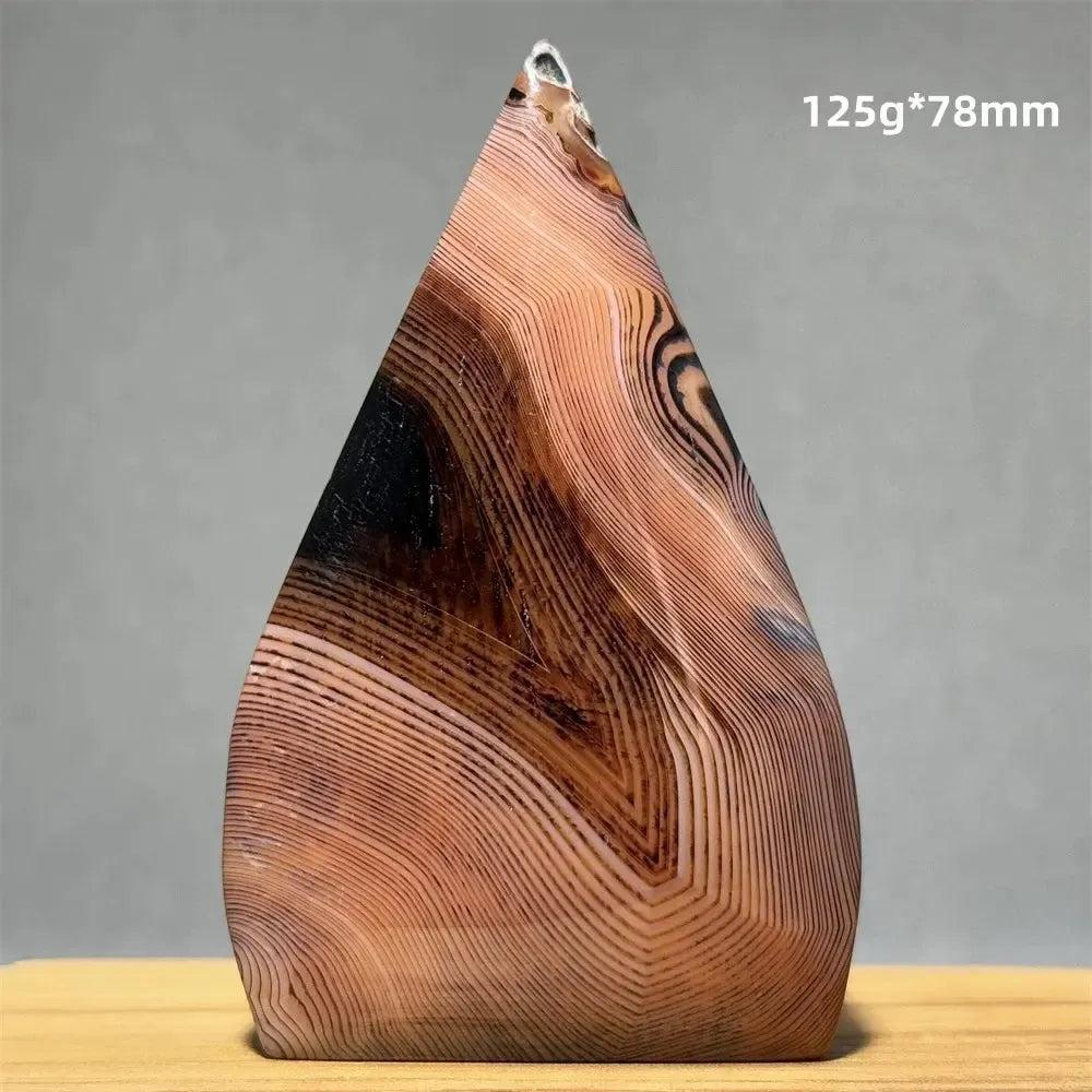 Banded Agate freeform torch from Crystal Destiny, featuring warm brown, black, and cream concentric stripes.