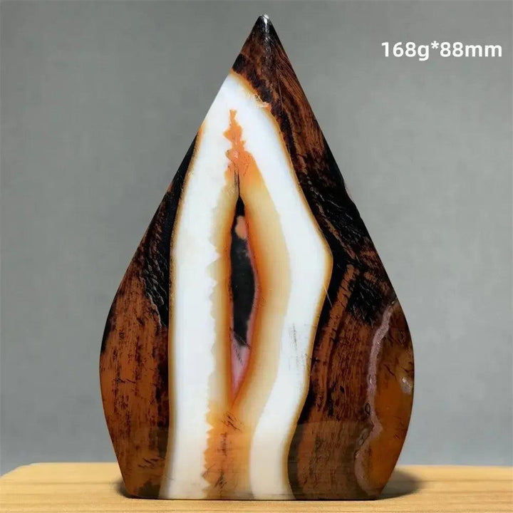 Banded Agate freeform torch from Crystal Destiny, featuring warm brown, white, and orange concentric stripes.
