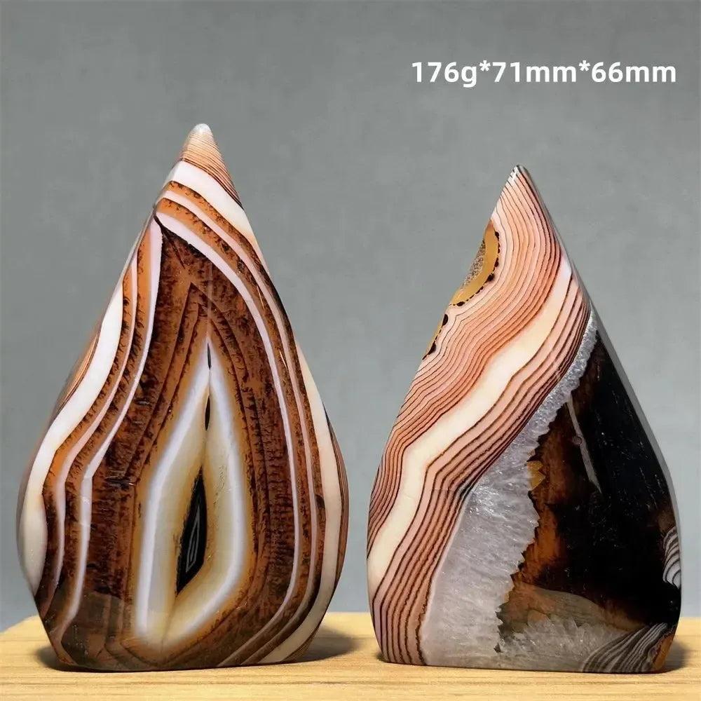 Two banded agate freeform torch crystals from Crystal Destiny, featuring warm brown, cream, and white layers.