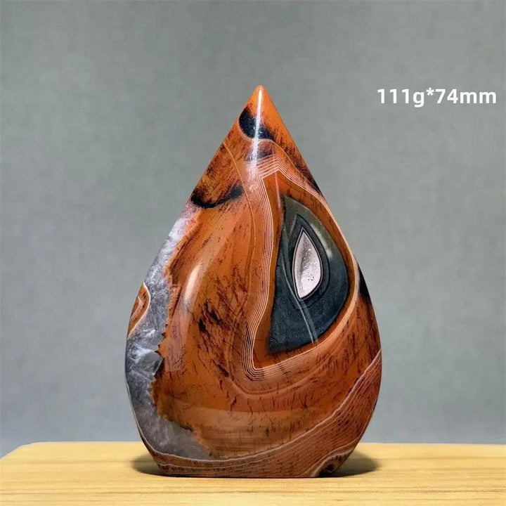 Banded Agate freeform torch from Crystal Destiny, featuring warm orange, brown, and grey concentric stripes.