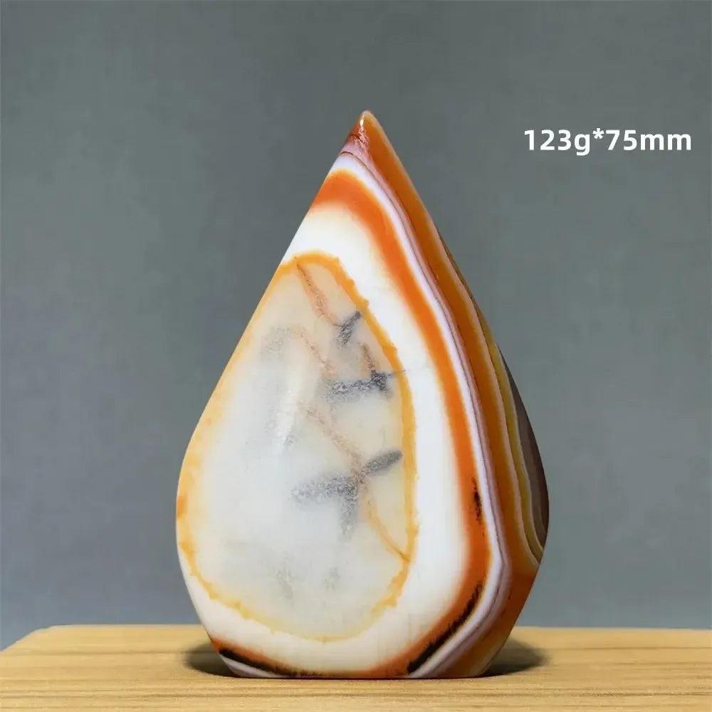 Banded Agate freeform torch from Crystal Destiny, featuring warm orange, white, and brown layers, 123g.