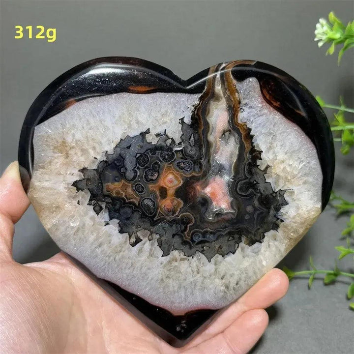 Banded Agate Geode Crystal Heart for Grounding & Stability, with bold red, black, brown, and white layers.