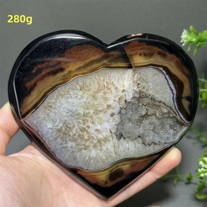 Banded Agate Geode Crystal Heart for Grounding & Stability, with red, black, brown, and white concentric layers.