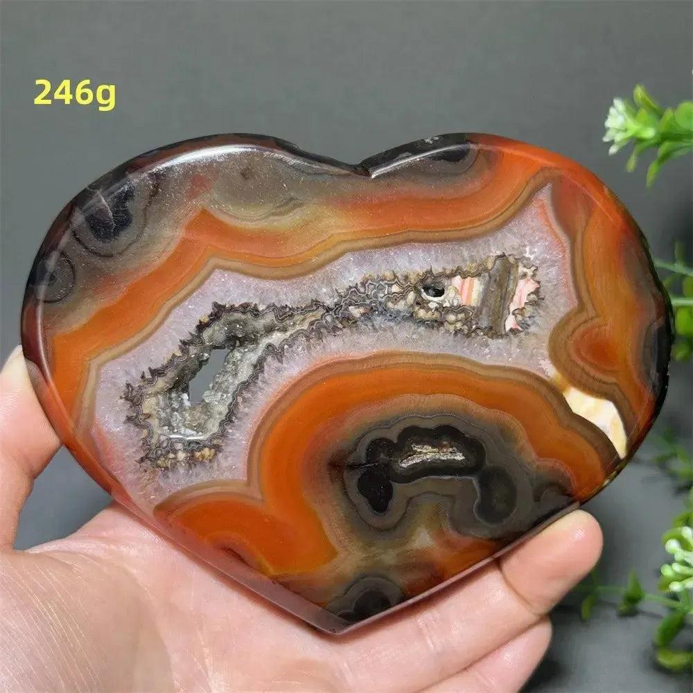 Banded Agate Geode Crystal Heart for Grounding & Stability, with red, black, brown, and white concentric layers.