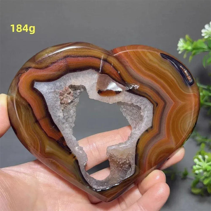 Banded Agate Geode Crystal Heart for Grounding & Stability, with red, black, brown, and white concentric layers.