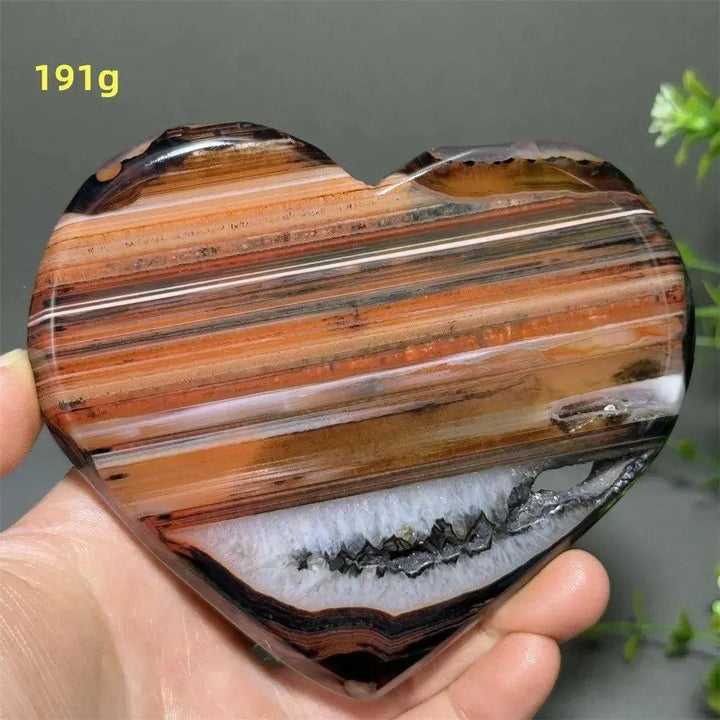 Banded Agate Geode Crystal Heart for Grounding & Stability, with red, black, brown, and white concentric layers.