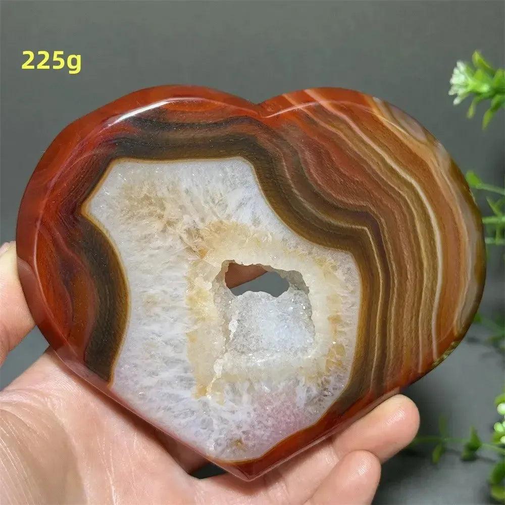Banded Agate Geode Crystal Heart for Grounding & Stability, with red, black, brown, and white concentric layers.