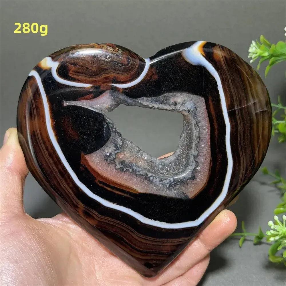 Banded Agate Geode Crystal Heart for Grounding & Stability, with bold red, black, brown, and white concentric layers.