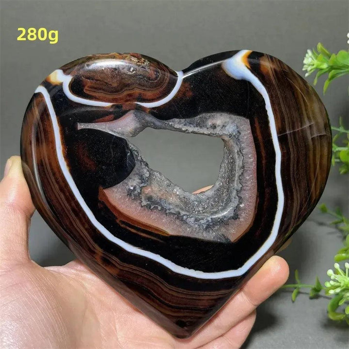 Banded Agate Geode Crystal Heart for Grounding & Stability, with bold red, black, brown, and white concentric layers.