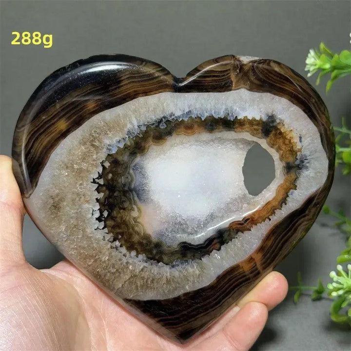 Banded Agate Geode Crystal Heart for Grounding & Stability, with bold red, black, brown, white concentric layers and a glittering druzy interior.