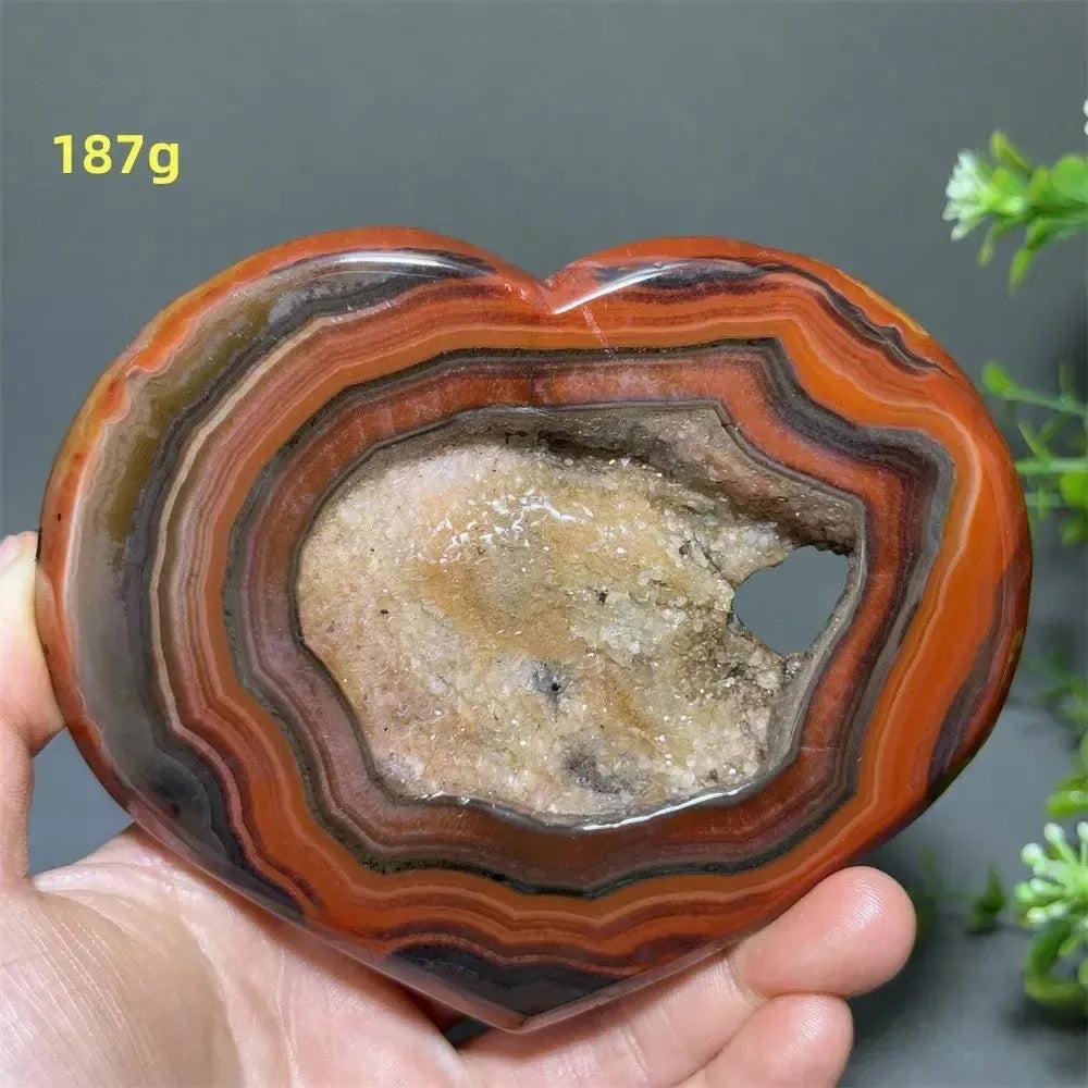 Banded Agate Geode Crystal Heart for Grounding & Stability, with red, black, brown, and white concentric layers.