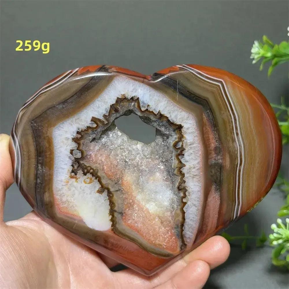 Banded Agate Geode Crystal Heart for Grounding & Stability, with red, black, brown, white layers, and druzy interior.