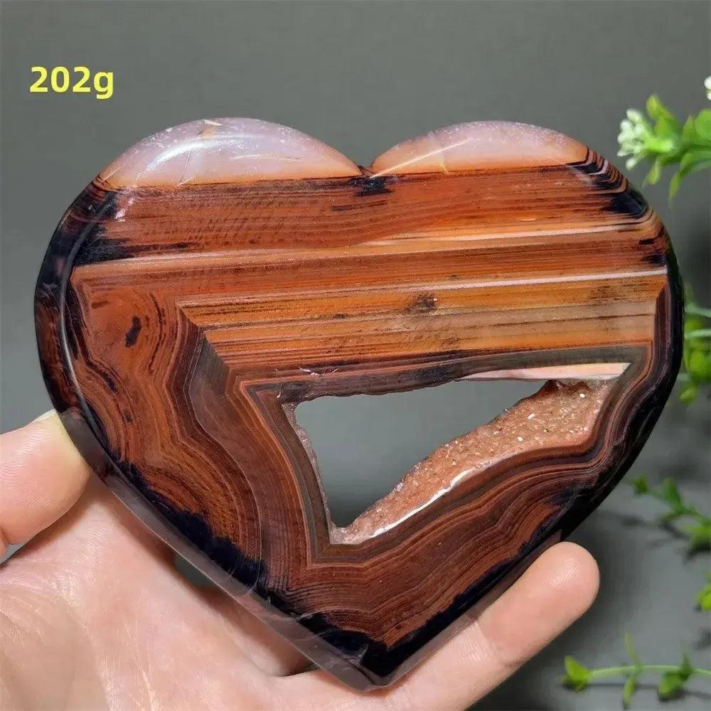 Banded Agate Geode Crystal Heart for Grounding & Stability, with bold red, black, brown, and white concentric layers.