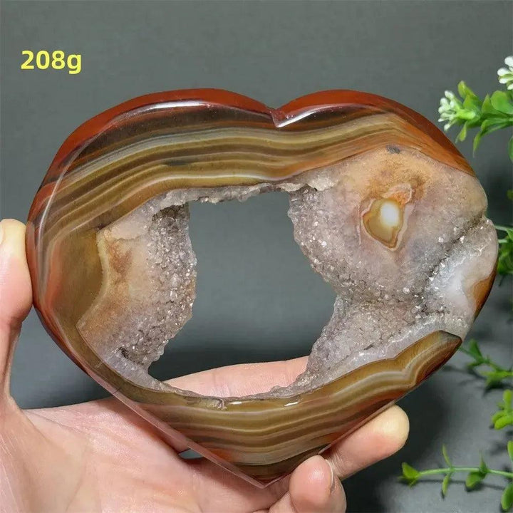Banded Agate Geode Crystal Heart for Grounding & Stability, with red, black, brown, and white concentric layers.