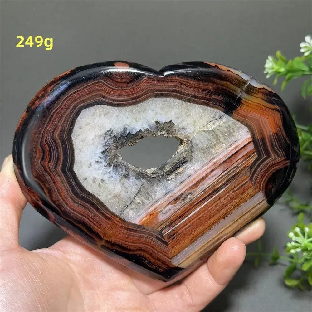 Banded Agate Geode Crystal Heart for Grounding & Stability, with red, black, brown, and white concentric layers.