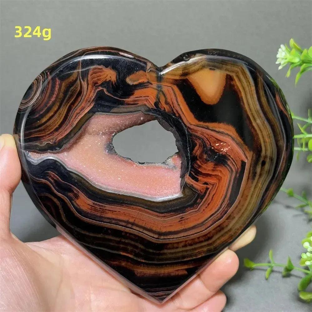 Banded Agate Geode Crystal Heart for Grounding & Stability, with red, black, brown, and white concentric layers.
