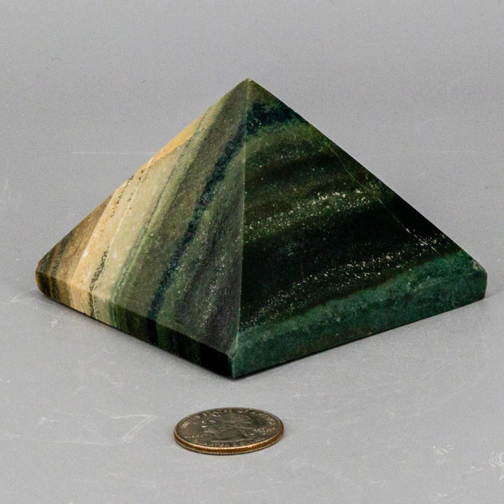 Polished Banded Calcite Pyramid with natural striped patterns in warm earthy tones, focusing grounding energy.