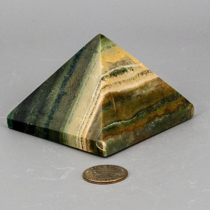 Polished Banded Calcite Pyramid with warm, earthy tones and natural striped patterns, focusing grounding energy.