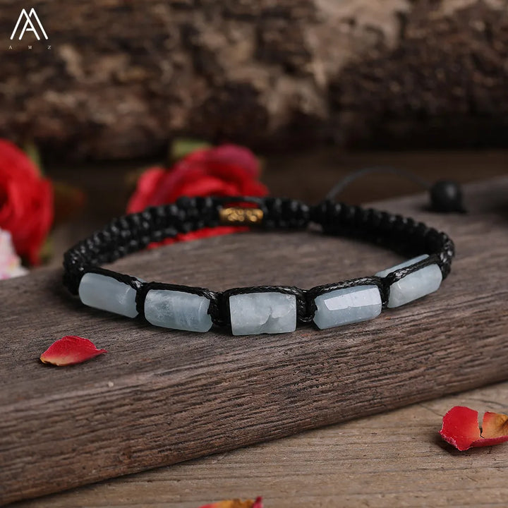 Adjustable barrel beaded bracelet featuring smooth, pale blue Amazonite stones on a durable black lace-up cord.