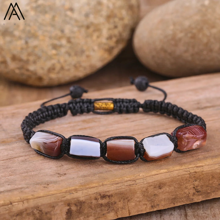Adjustable Barrel Beaded Agate bracelet with smooth, grounding earth-toned natural stone beads on a black cord.