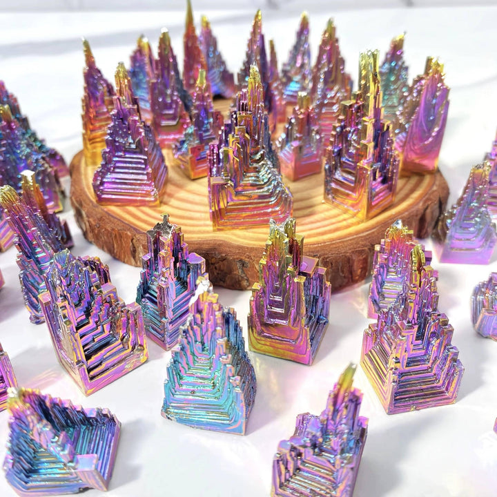 Iridescent Bismuth Metal Freeform Castles showcasing unique stair-step formations and vibrant rainbow colors.