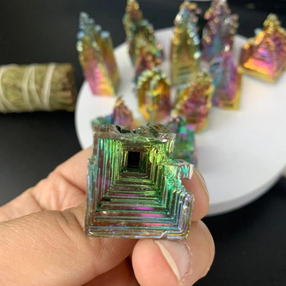 Iridescent Bismuth Crystal Pyramid for Manifestation, held in hand, showcasing rainbow colors and unique hopper structure.
