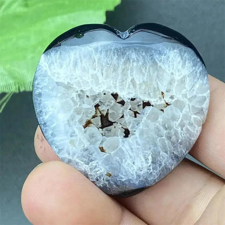Black Agate geode heart with a polished dark exterior and sparkling white druzy crystal interior.