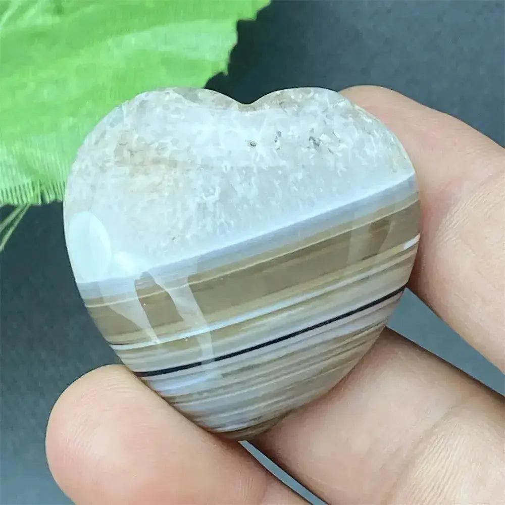 Polished Black Agate geode heart with natural druzy crystal cavity, offering grounding and protection.