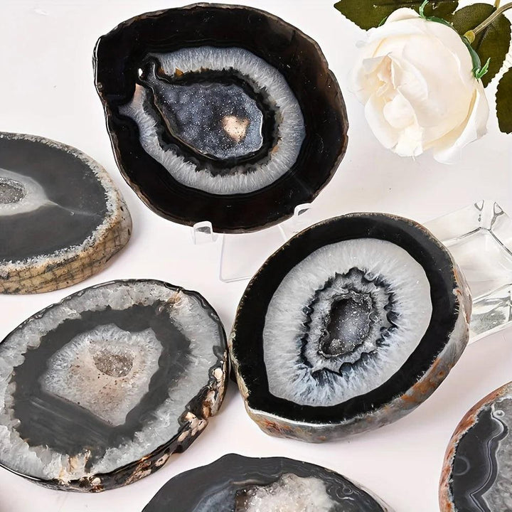 Polished Black Agate Crystal Geode Slices with raw edges and sparkling crystal inclusions for grounding.