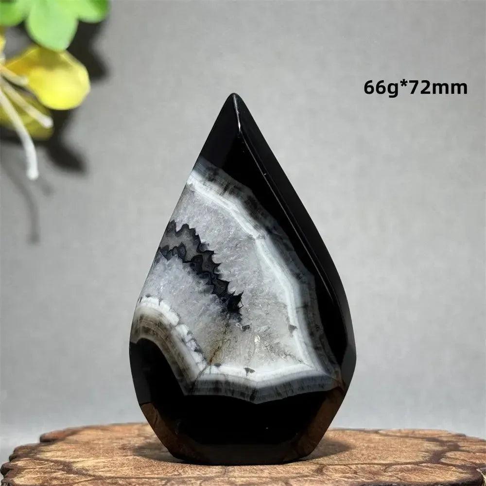 Black Agate Freeform Torch: Polished deep black agate with striking white and gray banding in a flame silhouette.