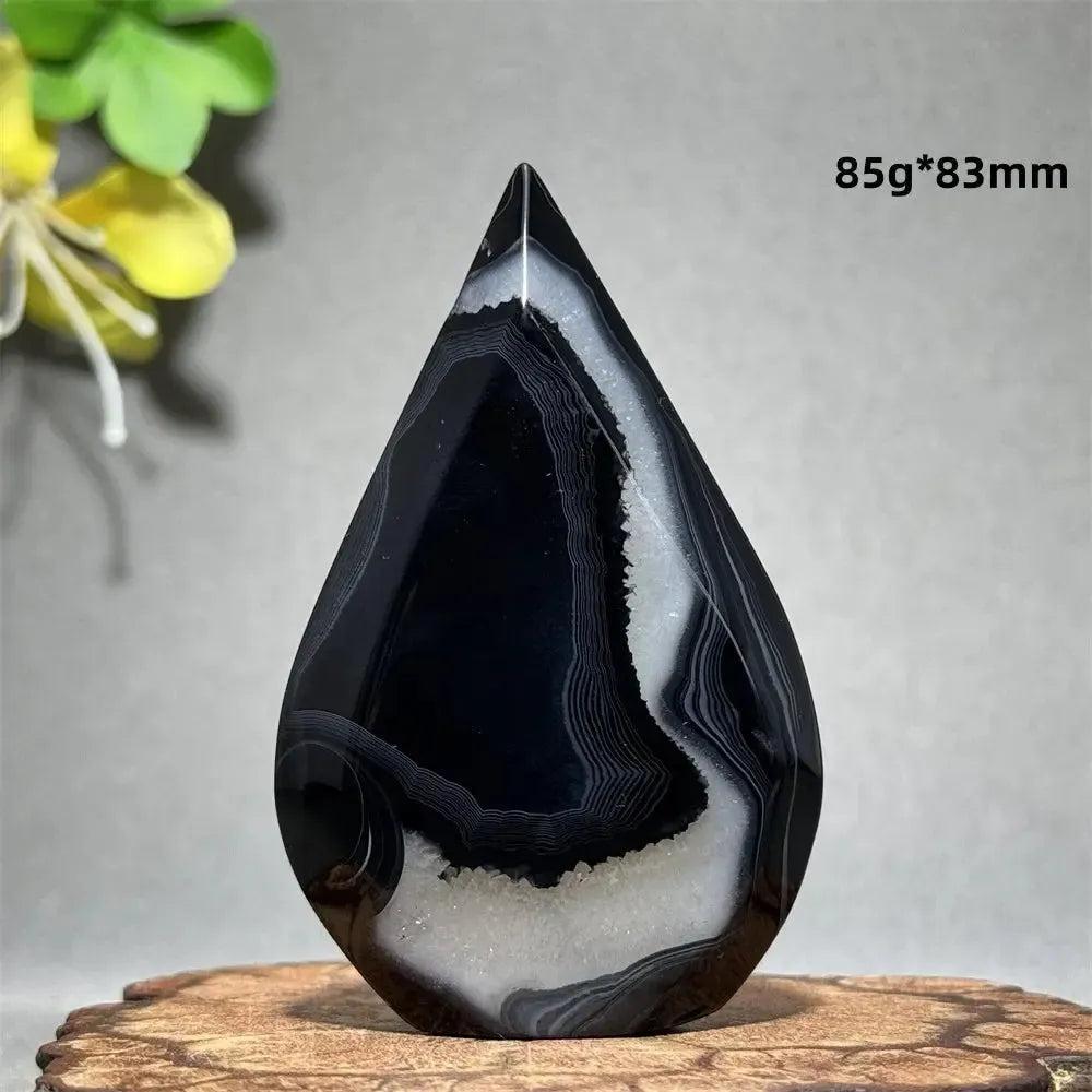 Polished Black Agate Freeform Torch with deep black, white, and gray banding, promoting grounding and protection.