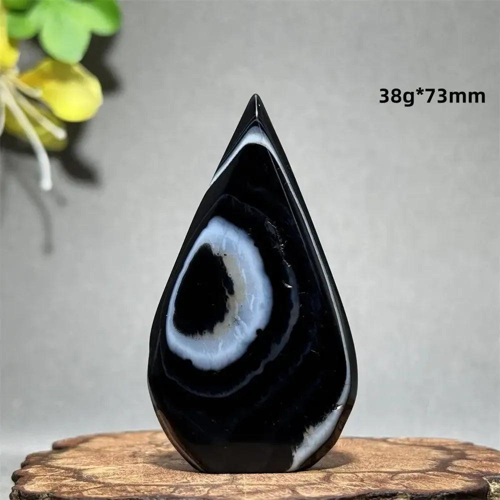 Black Agate Freeform Torch: Polished deep black agate with striking white and gray banding, flame silhouette.