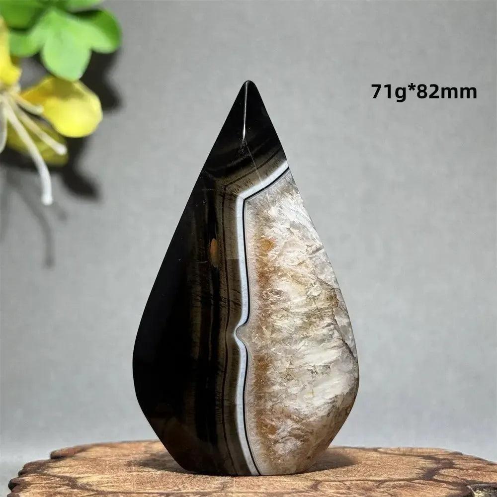 Polished Black Agate Freeform Torch with deep black, white, and gray banding, promoting grounding and protection.