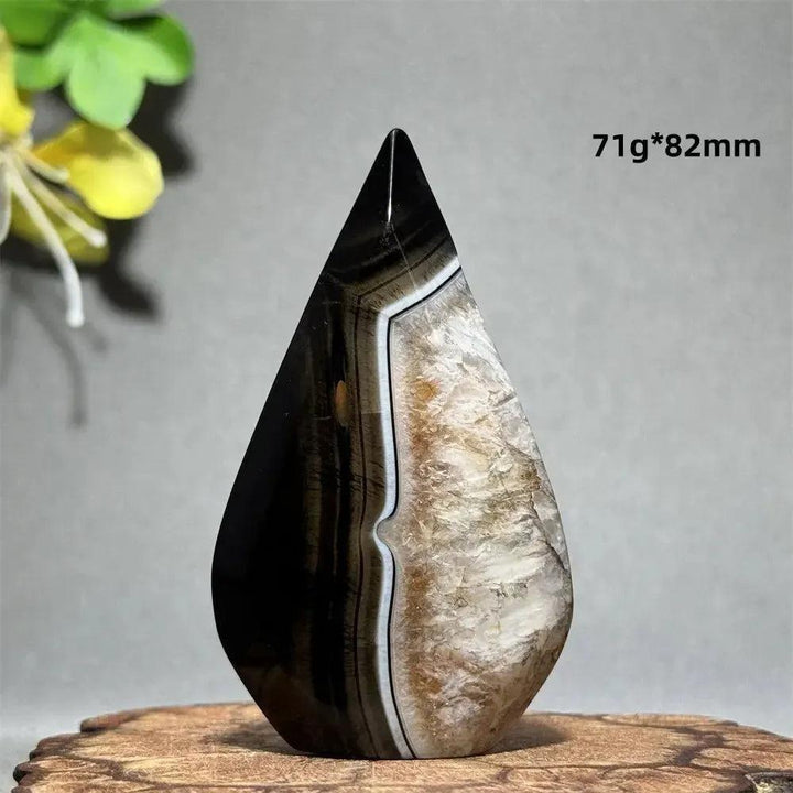 Polished Black Agate Freeform Torch with deep black, white, and gray banding, promoting grounding and protection.