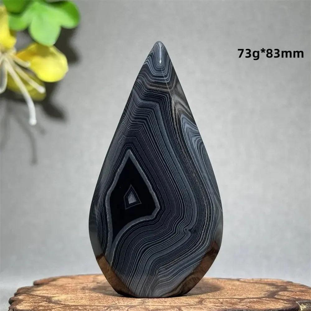 Polished Black Agate Freeform Torch with deep black, white, and gray banding, promoting grounding and protection.